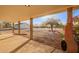 Covered patio overlooking a spacious yard, complete with desert landscaping and mountain views at 9121 W Quail W Trl, Queen Creek, AZ 85144
