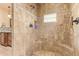 Tiled walk-in shower featuring a tiled bench, shower niche, shower head and handheld shower fixture at 9121 W Quail W Trl, Queen Creek, AZ 85144