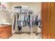 Walk-in closet with an array of clothing and storage containers on a wire rack shelf at 9121 W Quail W Trl, Queen Creek, AZ 85144
