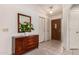 Light and bright foyer with a wooden dresser and tiled floor at 9521 E Hercules Dr, Sun Lakes, AZ 85248