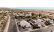 A high angle aerial view of a house with a beautiful desert landscape, green bushes, and mountain views at 1003 W Aire Libre Ave, Phoenix, AZ 85023