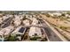 A high angle aerial view of a house with a beautiful desert landscape, green bushes, and mountain views at 1003 W Aire Libre Ave, Phoenix, AZ 85023