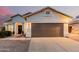 Attractive residence with a large garage door, decorative lighting, and a neatly kept yard at 1003 W Aire Libre Ave, Phoenix, AZ 85023