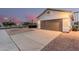 Lovely home on a corner lot with a wide driveway, desert landscaping, and a two-car garage at 1003 W Aire Libre Ave, Phoenix, AZ 85023