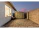 Backyard with shed and red wagon in gravel area, along the exterior wall of the house at 1003 W Aire Libre Ave, Phoenix, AZ 85023