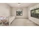 Simple bedroom with natural light, floral bedspread, and carpet flooring at 10031 E Nacoma Ct, Sun Lakes, AZ 85248