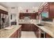 Kitchen featuring granite countertops, stainless steel appliances, and custom dark wood cabinetry at 10031 E Nacoma Ct, Sun Lakes, AZ 85248