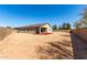 Expansive backyard featuring a neutral-toned home with a covered patio and a neatly bordered flower bed at 101 W Seven Seas Dr, Casa Grande, AZ 85122