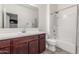 Bright bathroom featuring wood vanity, white countertops, and a shower-over-tub combo at 101 W Seven Seas Dr, Casa Grande, AZ 85122