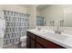 Bathroom featuring double sinks, large mirror and decorative shower curtain at 101 W Seven Seas Dr, Casa Grande, AZ 85122