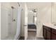 En suite bathroom showcasing a shower with a white shower surround, open door to the main bedroom at 101 W Seven Seas Dr, Casa Grande, AZ 85122