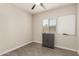 Bedroom features a window, cabinet, and a whiteboard for homeschooling or office use at 101 W Seven Seas Dr, Casa Grande, AZ 85122