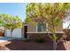 Charming single-story home showcasing a two-car garage, desert landscaping, and stone accents at 101 W Seven Seas Dr, Casa Grande, AZ 85122