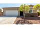 Charming single-story home showcasing a two-car garage, desert landscaping, and stone accents at 101 W Seven Seas Dr, Casa Grande, AZ 85122