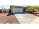 Charming single-story home showcasing a two-car garage, desert landscaping, and stone accents at 101 W Seven Seas Dr, Casa Grande, AZ 85122