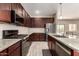 Modern kitchen features granite counters, stainless appliances, dark cabinets, and tile floors at 101 W Seven Seas Dr, Casa Grande, AZ 85122