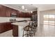Modern kitchen with stainless steel appliances, granite countertops, and an island with bar seating at 101 W Seven Seas Dr, Casa Grande, AZ 85122