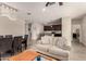 Bright living room with a view of the kitchen featuring modern furniture and wood-look tile flooring at 101 W Seven Seas Dr, Casa Grande, AZ 85122