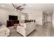 Bright living room featuring modern furniture, a ceiling fan, and wood-look tile flooring at 101 W Seven Seas Dr, Casa Grande, AZ 85122