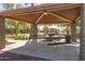 Shaded community picnic area featuring multiple tables and park views, perfect for Gathering gatherings and relaxing at 101 W Seven Seas Dr, Casa Grande, AZ 85122