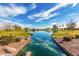 Picturesque pond framed by lush landscaping and serene reflections, offering residents a beautiful natural oasis at 101 W Seven Seas Dr, Casa Grande, AZ 85122