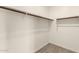 Walk-in closet with wood-look tile flooring and shelving for optimal storage and organization at 101 W Seven Seas Dr, Casa Grande, AZ 85122