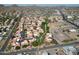Extensive aerial view of residences with green spaces, a community park, and nearby amenities such as tennis courts at 10224 N 12Th Pl # 1, Phoenix, AZ 85020