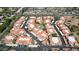 An aerial view of a condo community reveals terracotta roofs, ample parking, and a sparkling community pool at 10224 N 12Th Pl # 1, Phoenix, AZ 85020