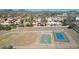 Aerial view shows the basketball and tennis courts, surrounded by a desert landscape and residential area at 10224 N 12Th Pl # 1, Phoenix, AZ 85020