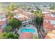 Aerial view shows well-maintained condo community with pool, spa, palm trees, and mountain views in the background at 10224 N 12Th Pl # 1, Phoenix, AZ 85020