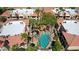 An aerial view captures a community pool with shade structures, surrounded by terracotta-roofed buildings at 10224 N 12Th Pl # 1, Phoenix, AZ 85020