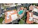 Aerial view shows a community with a pool area with palm trees and terracotta roofs at 10224 N 12Th Pl # 1, Phoenix, AZ 85020