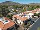 Aerial view of townhome complex showcasing tile roofs, private patios, and nearby mountain views at 10224 N 12Th Pl # 1, Phoenix, AZ 85020