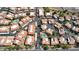 Detailed aerial view of a community with red-tiled roofs, pools, parking areas, and lush, green landscaping at 10224 N 12Th Pl # 1, Phoenix, AZ 85020