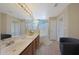 Bright bathroom with double sinks, a glass-enclosed shower, and neutral tile at 10224 N 12Th Pl # 1, Phoenix, AZ 85020
