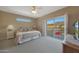 Bright bedroom with a ceiling fan and sliding doors to a balcony at 10224 N 12Th Pl # 1, Phoenix, AZ 85020