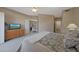 Bedroom featuring a ceiling fan, dresser, and access to the upstairs loft area at 10224 N 12Th Pl # 1, Phoenix, AZ 85020