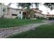 Beautiful multi-story building exterior surrounded by vibrant green landscaping, rock feature, and trees at 10224 N 12Th Pl # 1, Phoenix, AZ 85020
