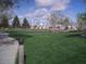 Lush community park with sprawling green grass, mature trees, volleyball net, and basketball court at 10224 N 12Th Pl # 1, Phoenix, AZ 85020