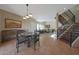 Open dining area with a glass-top table and direct access to the living room and staircase at 10224 N 12Th Pl # 1, Phoenix, AZ 85020
