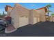 Exterior view of condo unit showing multiple private garages and well-kept landscaping at 10224 N 12Th Pl # 1, Phoenix, AZ 85020