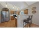 Spacious kitchen features stainless steel appliances, wood cabinets, tile floors, and bar seating at 10224 N 12Th Pl # 1, Phoenix, AZ 85020