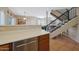 Open-concept kitchen showcasing wood cabinets and stainless steel dishwasher adjacent to staircase at 10224 N 12Th Pl # 1, Phoenix, AZ 85020