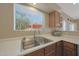 Well-lit kitchen sink area featuring a window with natural light and ample counter space at 10224 N 12Th Pl # 1, Phoenix, AZ 85020