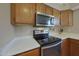 Close-up of the kitchen's stainless steel oven and stove, with tile floors and a white countertop at 10224 N 12Th Pl # 1, Phoenix, AZ 85020
