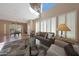Bright living room with tile flooring, leather sofa, and an abundance of natural light from large windows at 10224 N 12Th Pl # 1, Phoenix, AZ 85020