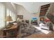 Inviting living room featuring high ceilings, natural light, comfortable seating, and a cozy fireplace at 10224 N 12Th Pl # 1, Phoenix, AZ 85020