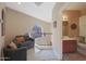 Comfortable loft area with seating, leading to a bathroom with a wooden vanity at 10224 N 12Th Pl # 1, Phoenix, AZ 85020