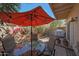 Patio with dining table under an umbrella, surrounded by lush plants and a brick-paved area at 10224 N 12Th Pl # 1, Phoenix, AZ 85020
