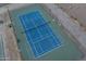 Aerial view of well-maintained community pickleball courts with vibrant blue playing surfaces and lush green surroundings at 10224 N 12Th Pl # 1, Phoenix, AZ 85020